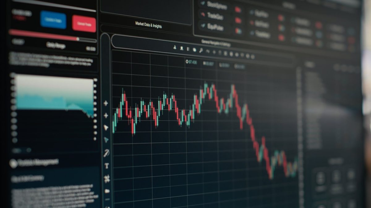 A computer screen shows a red and green candlestick chart with side panels and buttons.